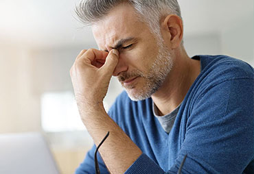 Man needing migraine relief with acupuncture