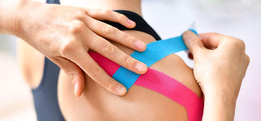 Patient recieving Kinesio & RockTaping after an auto accident for pain relief